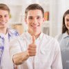 Young People Showing Their Thumbs Up Stock Photo