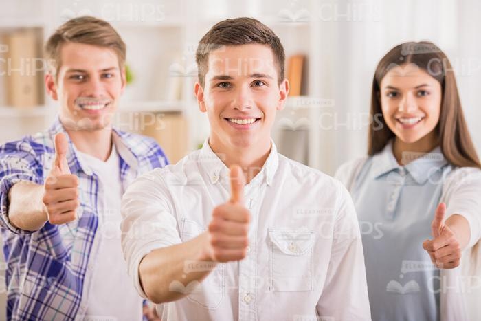 Young People Showing Their Thumbs Up Stock Photo
