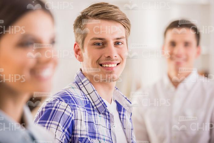 Young Man And His Classmates Stock Photo