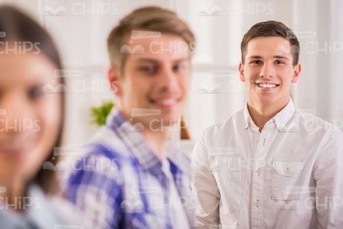 Smiling Man In White Shirt With Collegues Stock Photo