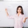 Young Woman Standing Next To Whiteboard Stock Photo