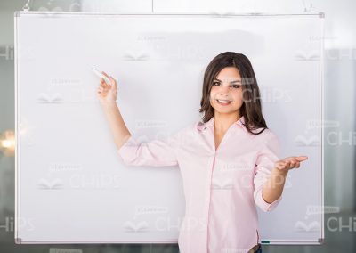 Young Woman Standing Next To Whiteboard Stock Photo