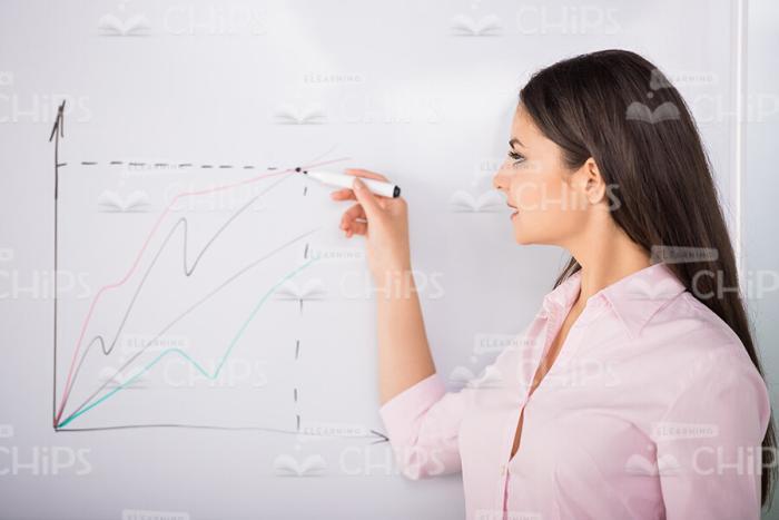 Handsome Woman Using Marker To Draw Graph Stock Photo