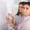 Two Women Conduct Business Training Stock Photo