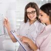 Women Use Flip Chart While Drawing Graph Stock Photo