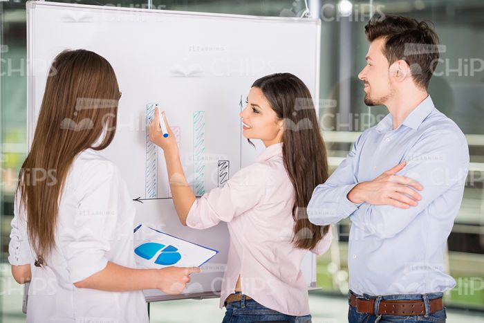 Several Business People Discuss Graph Stock Photo
