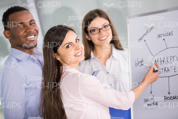 Team Of Managers Presenting Graph On Whiteboard Stock Photo