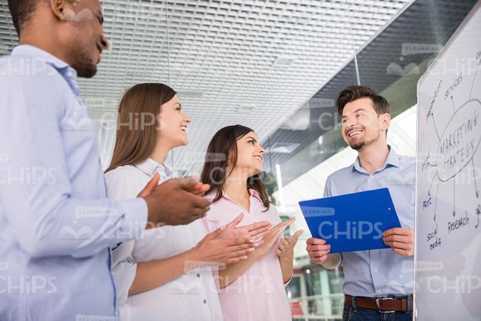 Learners Clapping Hands To Business Coach Stock Photo