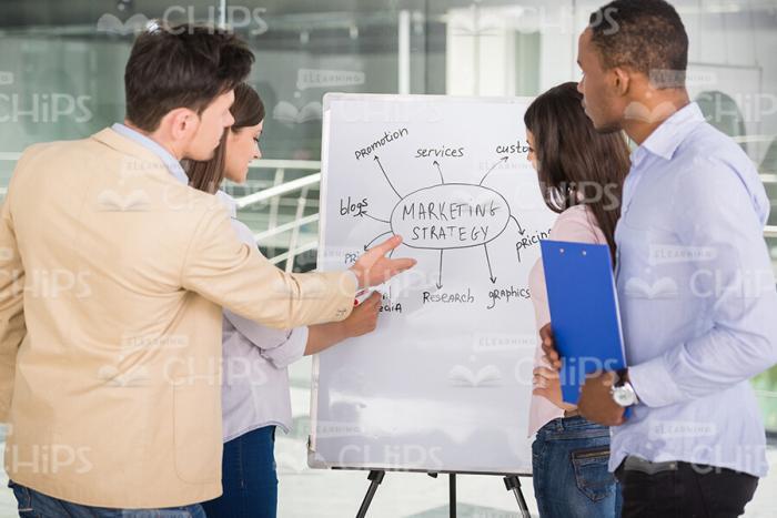 Attentive Business People Talking About Graph Stock Photo