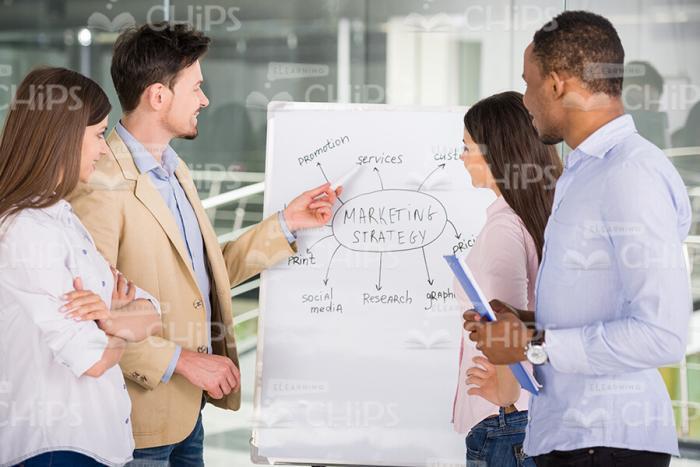 Young Business People Standing Next To Flipchart Stock Photo