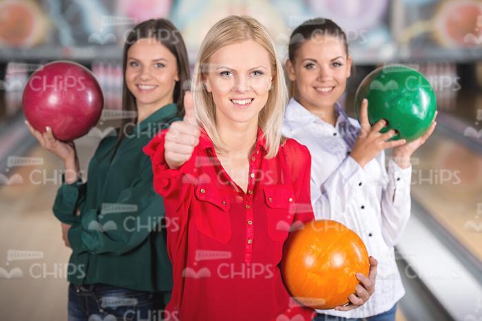 Women With Bowling Balls Posing For Camera Stock Photo