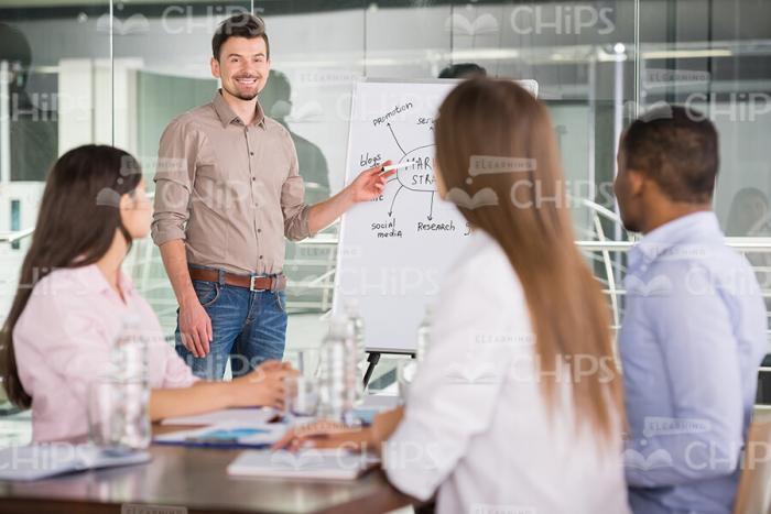 Four Young People Having Business Conversation Stock Photo