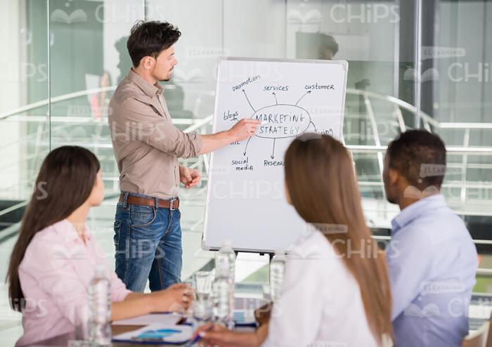 Bearded Man Presenting Course Information To The Audience Stock Photo