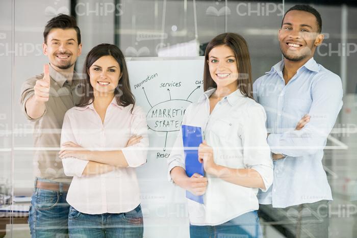 Self-Confident Business People Standing Near The Flipchart Stock Photo