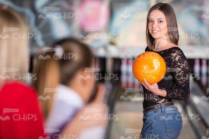 Nice Girl Holds Orange Bowling Ball Stock Photo
