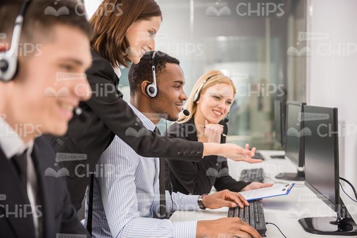 Four Young People Working In Call Center Stock Photo
