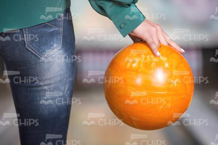 Close Up Stock Photo Of Orange Bowling Ball In Woman's Hand