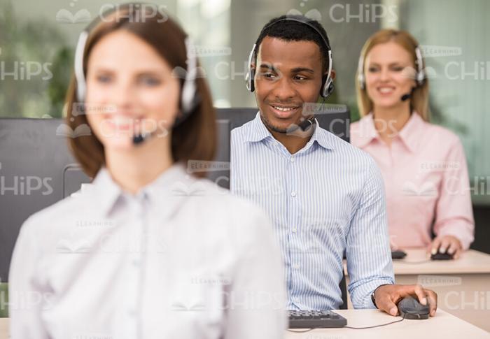 Smiling Young People Working In Call Center Stock Photo