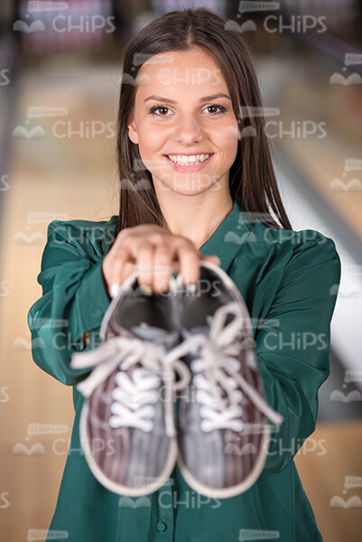 Young Lady Showing Bowling Shoes Stock Photo