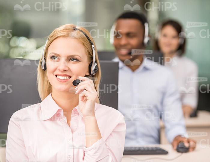 Young lady Talking The Phone At Work Stock Photo