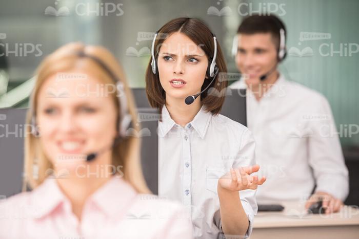 Pensive Woman Gesturing While Working Stock Photo