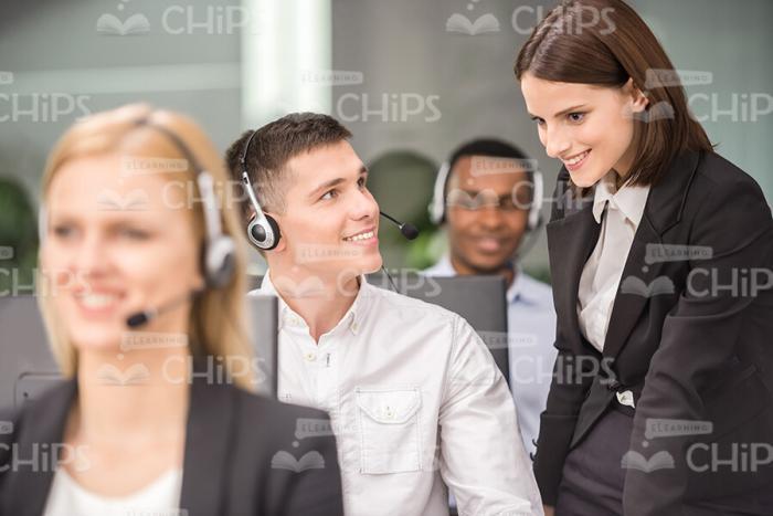 Smiling Male Operator And Friendly Female Manager Stock Photo