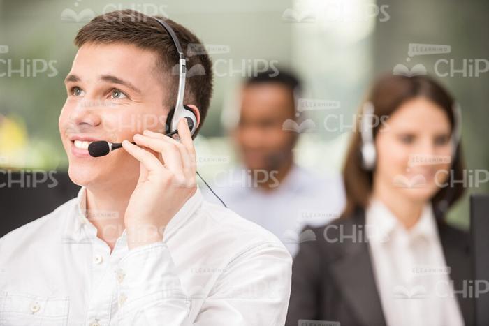 Smiling Call Center Operator Looking Up Stock Photo