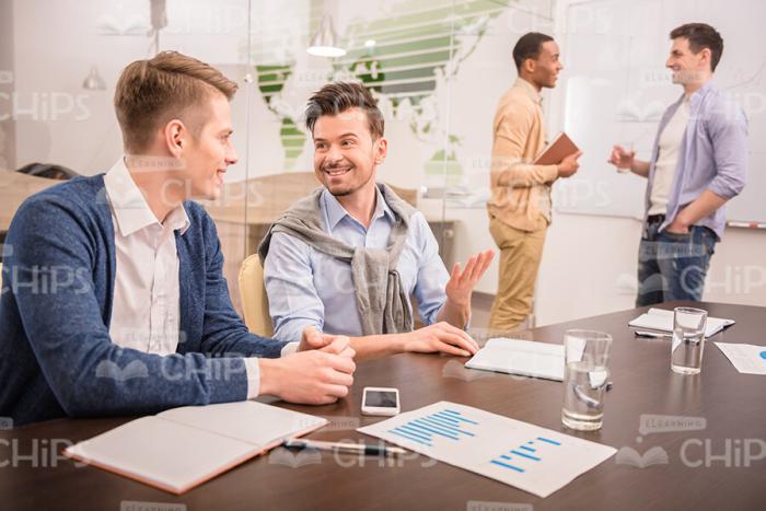 Young Men Involved In Business Conference Stock Photo