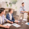 Coach Greets Learner In Meeting Room Stock Photo