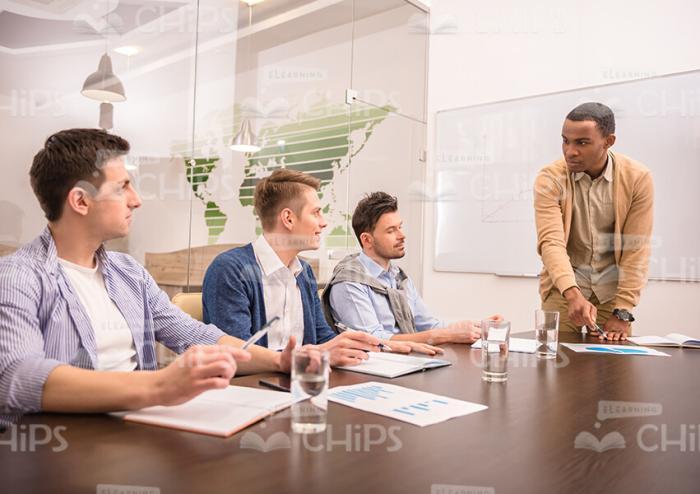 Handsome Young Mentor Holding Training Session Stock Photo