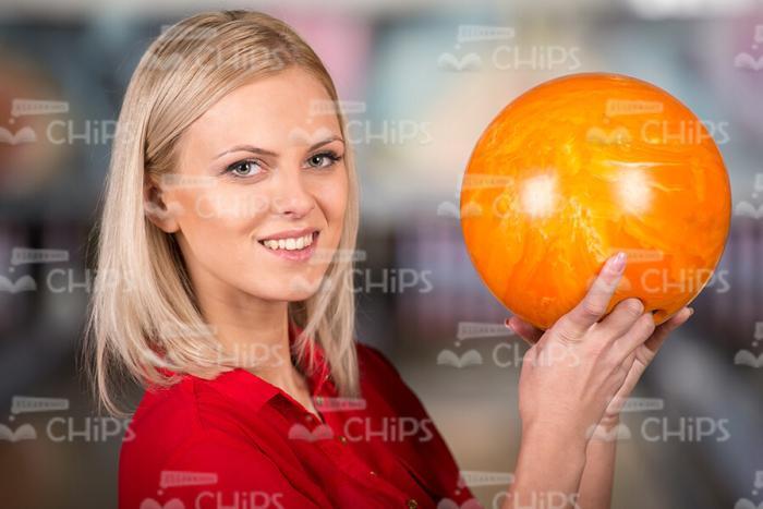 Blonde Woman Holding Bowling Ball With Right Hand Stock Photo