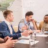 Angry Business Coach Sitting And Throwing Hands Up Stock Photo