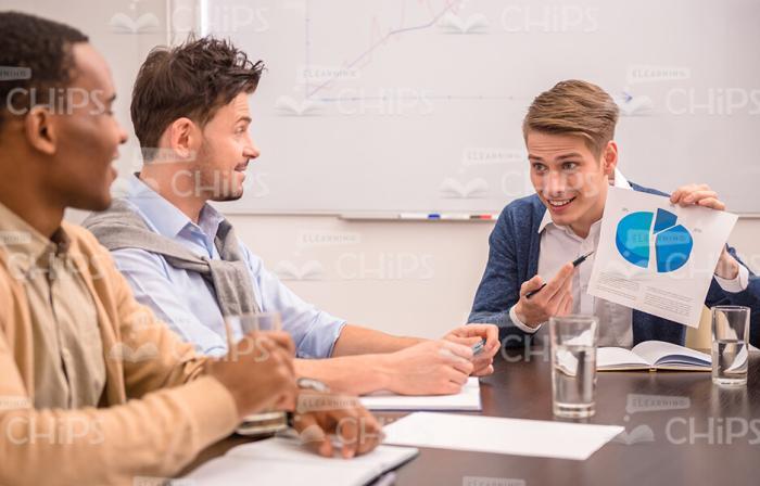 Young Man Presenting Circle Diagram Stock Photo