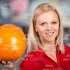 Blonde Woman In Red Blouse Holds Bowling Ball Stock Photo