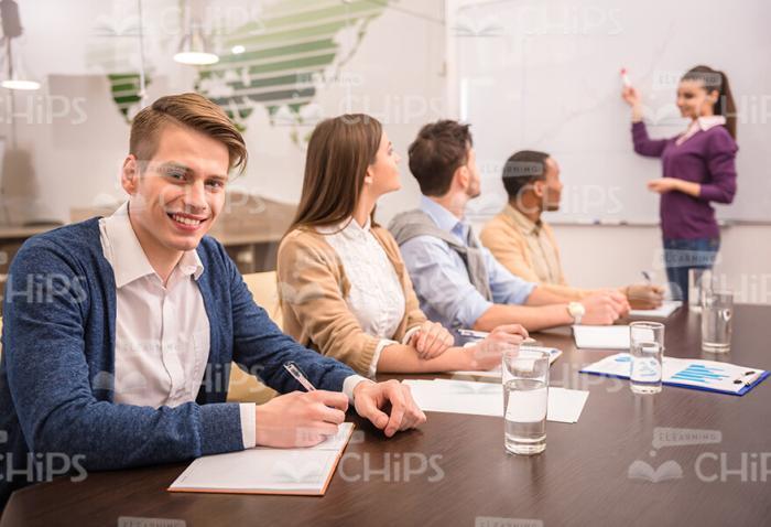 Smiling Man With Colleagues On Business Meeting Stock Photo