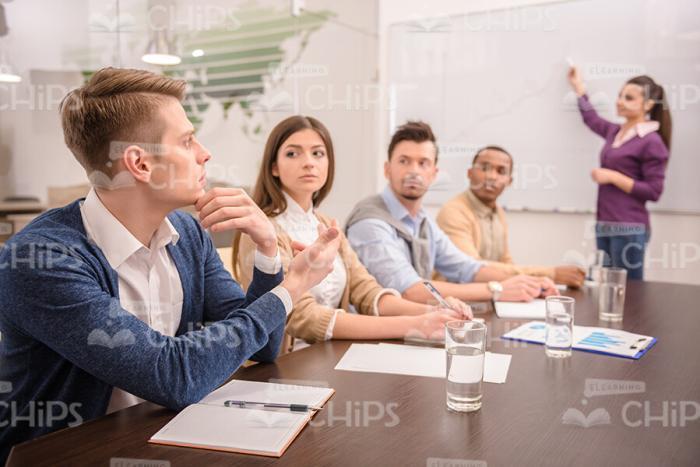 Young Man On Business Meeting Asks Question Stock Photo