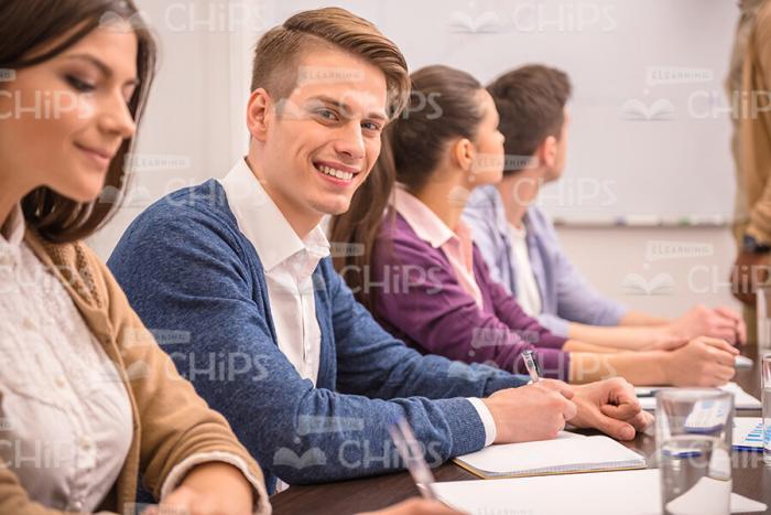 Young Man Making Notes At Conference Stock Photo