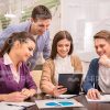 Friendly Business Team Looking At Chart Stock Photo