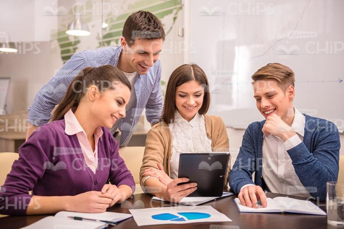 Friendly Business Team Looking At Chart Stock Photo