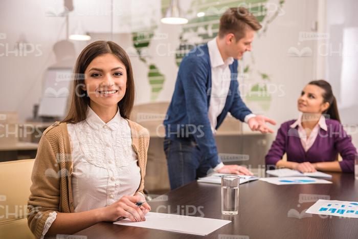Cute Young Woman In Front Of Her Colleagues Stock Photo