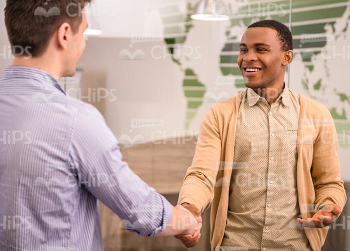 Black Young Man Greets His Colleague Stock Photo