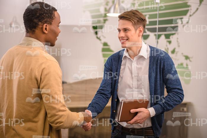 Two Men Shakes Hands While Says Bye To Each Other Stock Photo