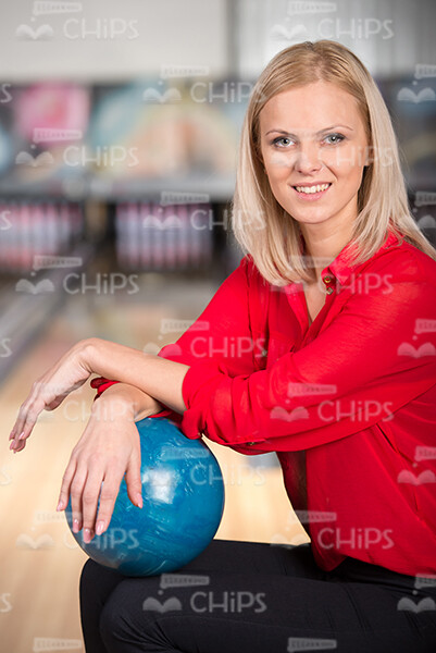Blonde Lady Puts Hands On Blue Bowling Ball Stock Photo