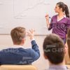Young Man Pointing On Whiteboard And Saying Something To Female Narrator Stock Photo