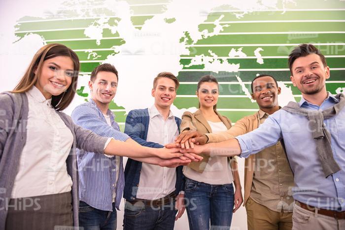 Friendly Business Team Members Put Their Hands On Top Of Each Other Stock Photo