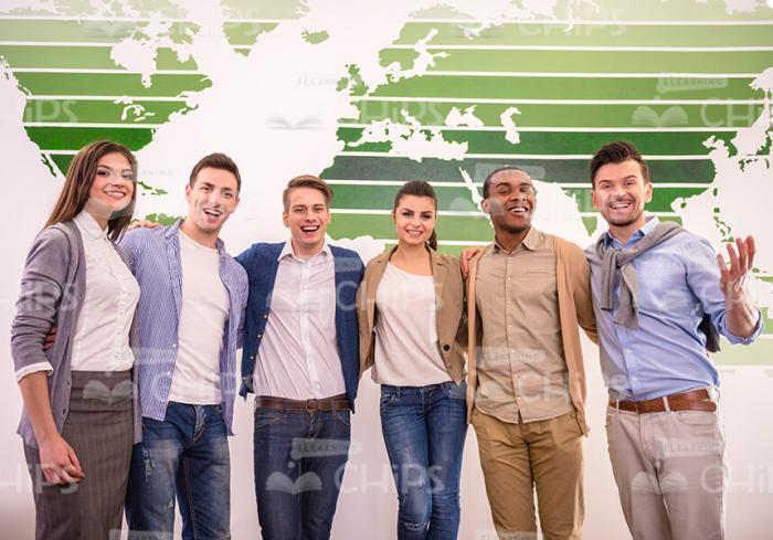 Conference Participants Hugging While Posing For Camera Stock Photo