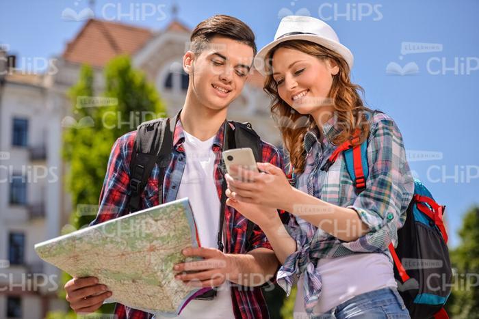 Cheerful Couple Of Tourists Looking For The Best Route Stock Photo