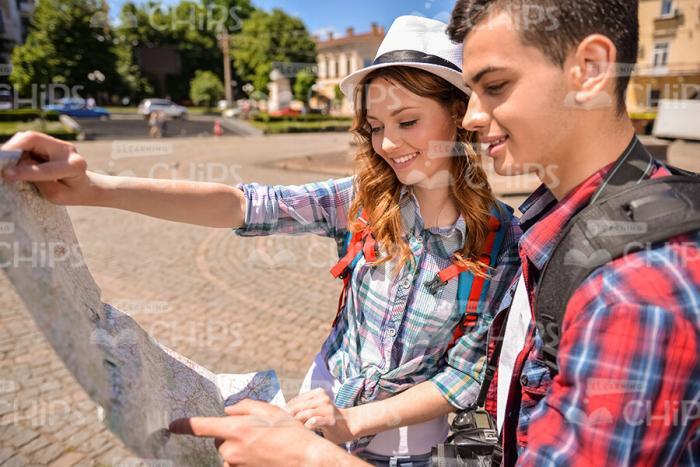 Handsome Young People Using Map To Choose Best Route Stock Photo