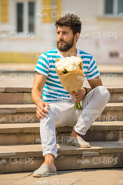Good-Looking Young Man With Bouquet Stock Photo