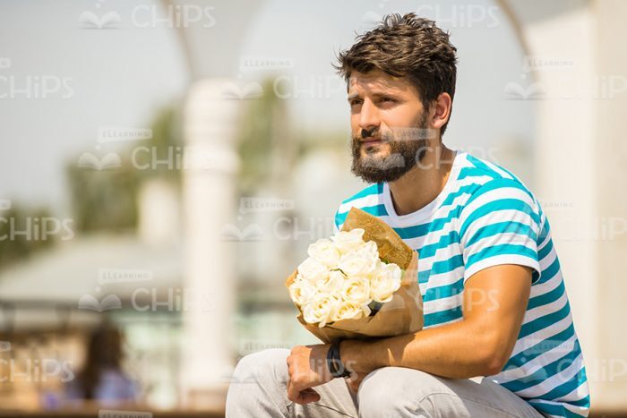 Bearded Guy With Bouquet Waiting For Friend Stock Photo